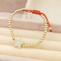Bransoletka POZŁACANA gwiazdka kuleczki czerwony sznurek rose gold