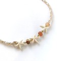 Naszyjnik rozgwiazdy beżowe koraliki złote kulki ze STALI CHIRURGICZNEJ